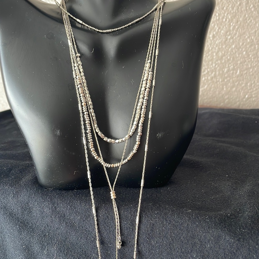 Beautiful 4 chain layered silver necklace.